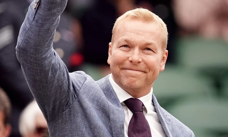 Olympian Sir Chris Hoy smiling and waving 