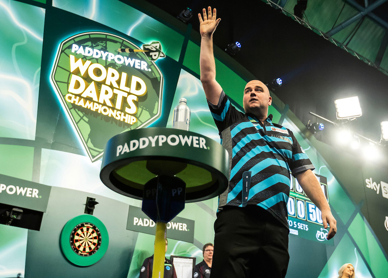 Darts player Rob Cross waves to the crowd at the World Darts Championship in 2023.