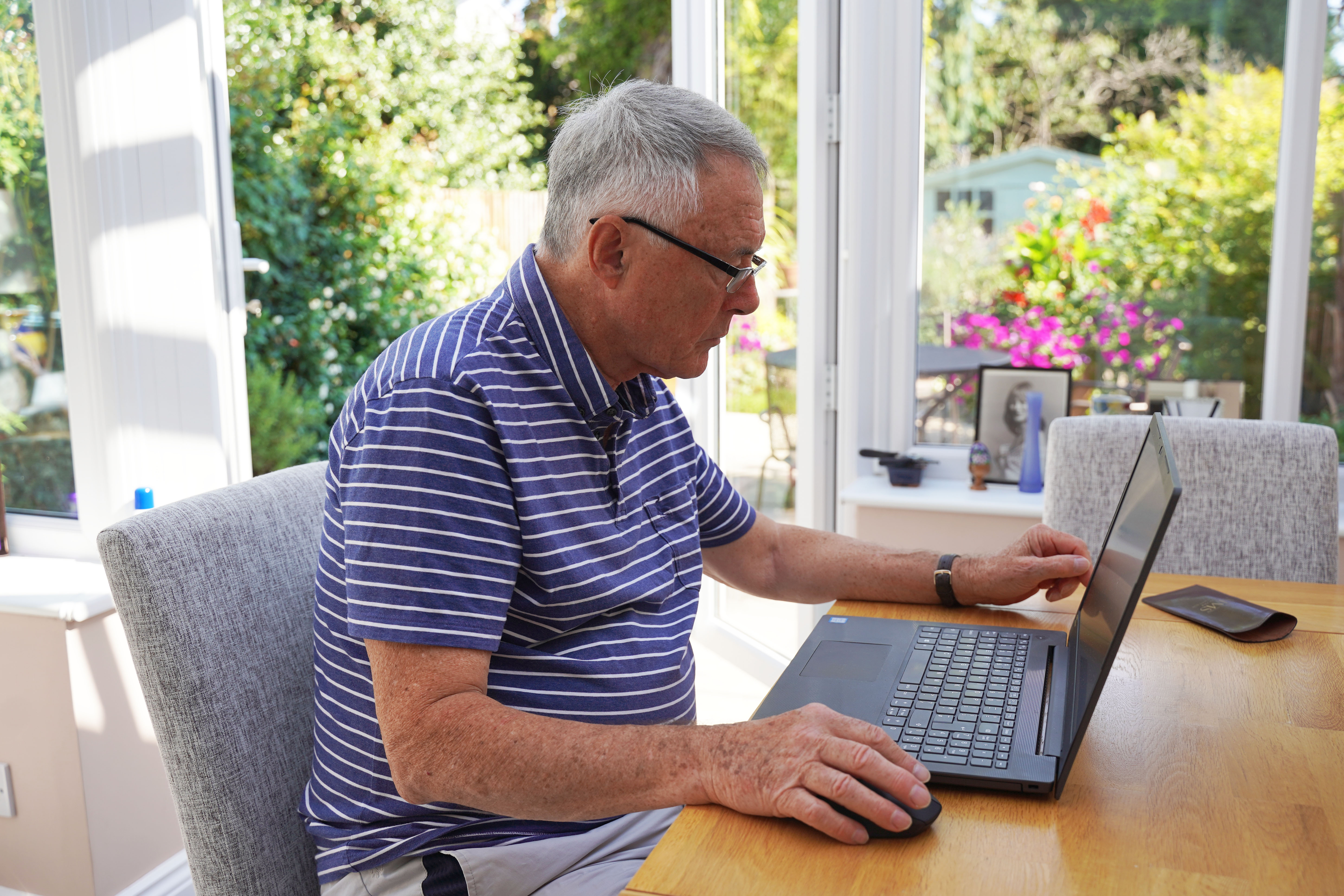 A man sitting at desk with his laptop