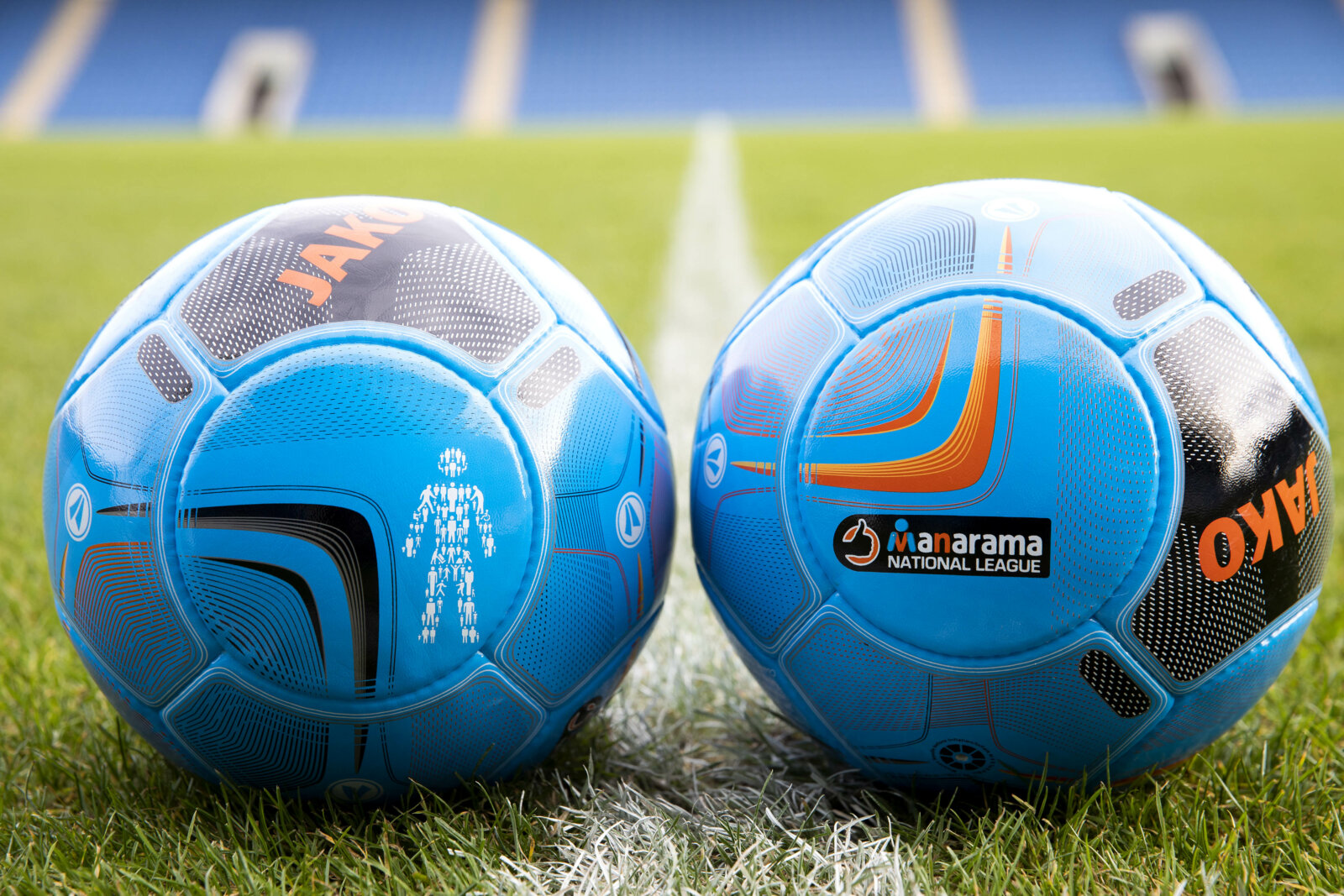 A close-up image of two footballs, one featuring the Prostate Cancer UK logo and one featuring the Vanarama logo.