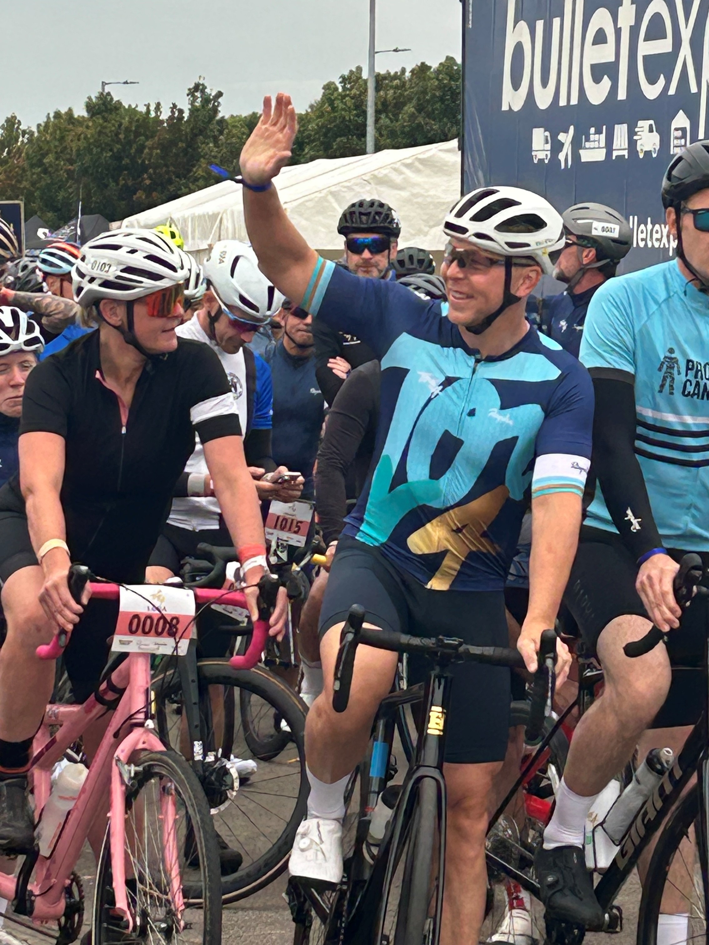 Sir Chris Hoy at the Tour de 4 cycle challenge setting off on his bike and waving