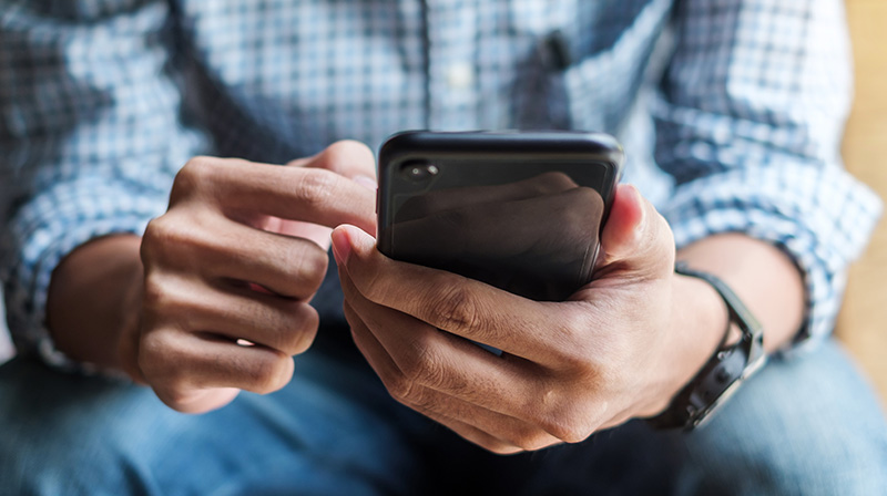 Close up of a person's hands holding a mobile phone