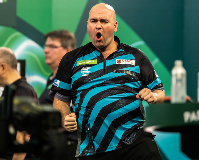 Rob Cross punches the air in celebration during a match at the World Darts Championship at Alexandra Palace