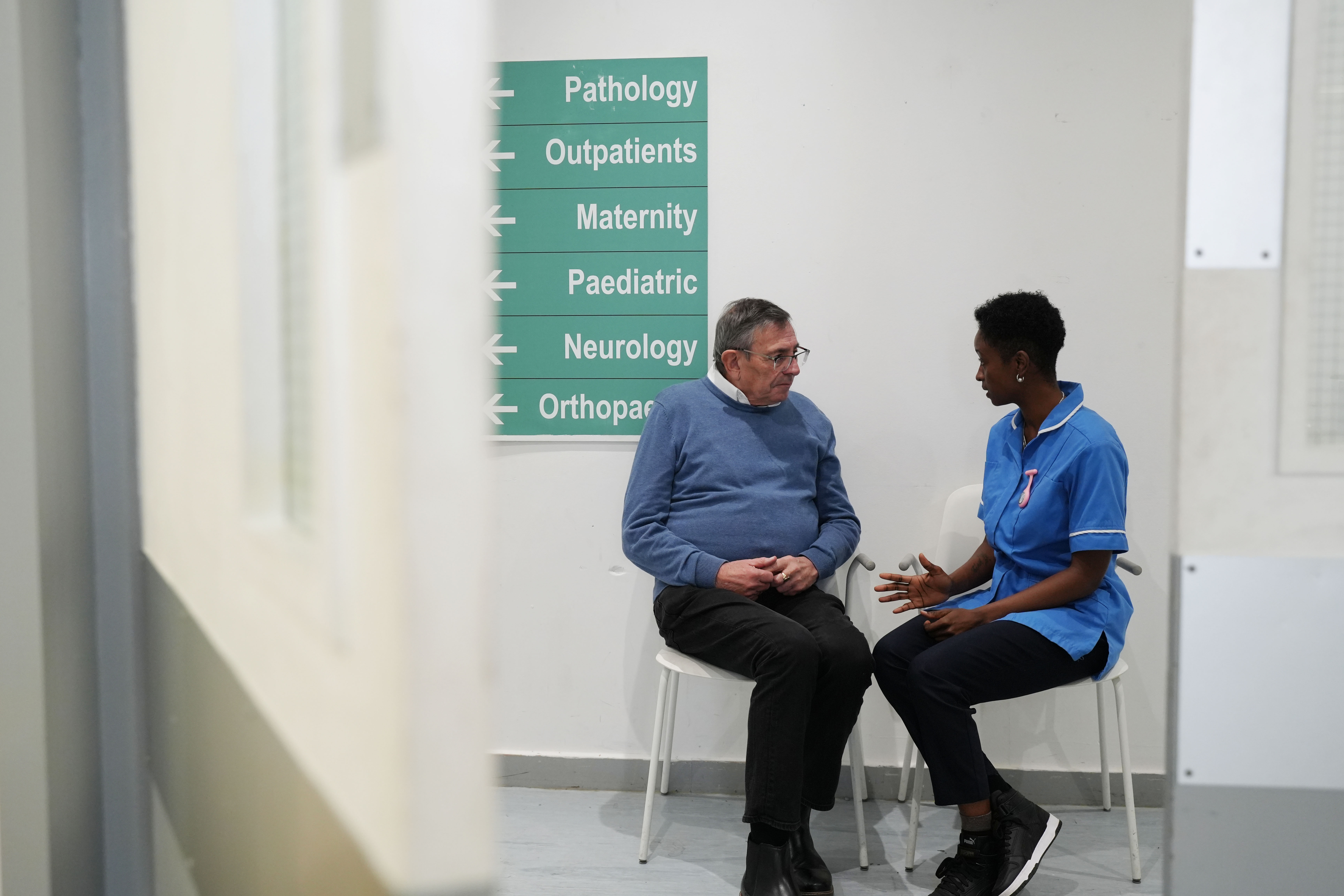 A nurse talking to a patient.