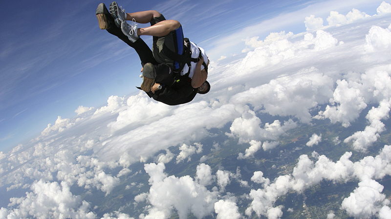 Two people strapped together doing a skydive