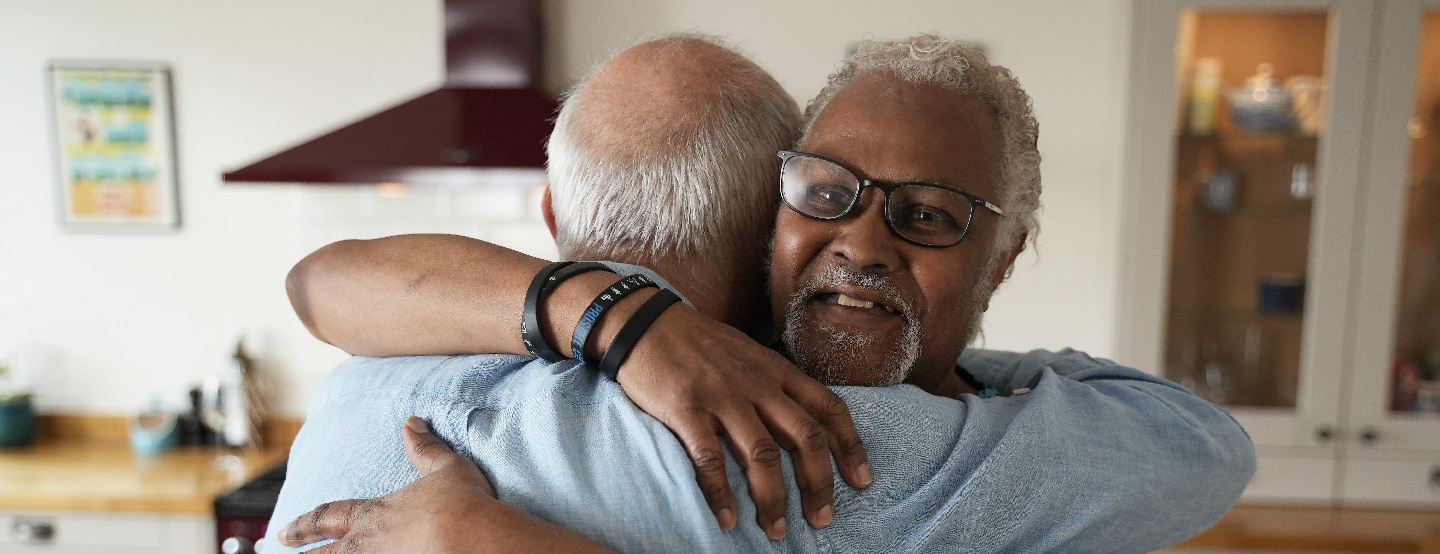 Two men hugging
