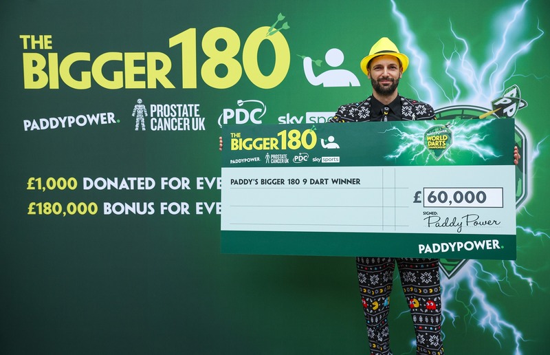 Mauro, from Switzerland, celebrates holding a giant cheque after winning the £60,000 prize