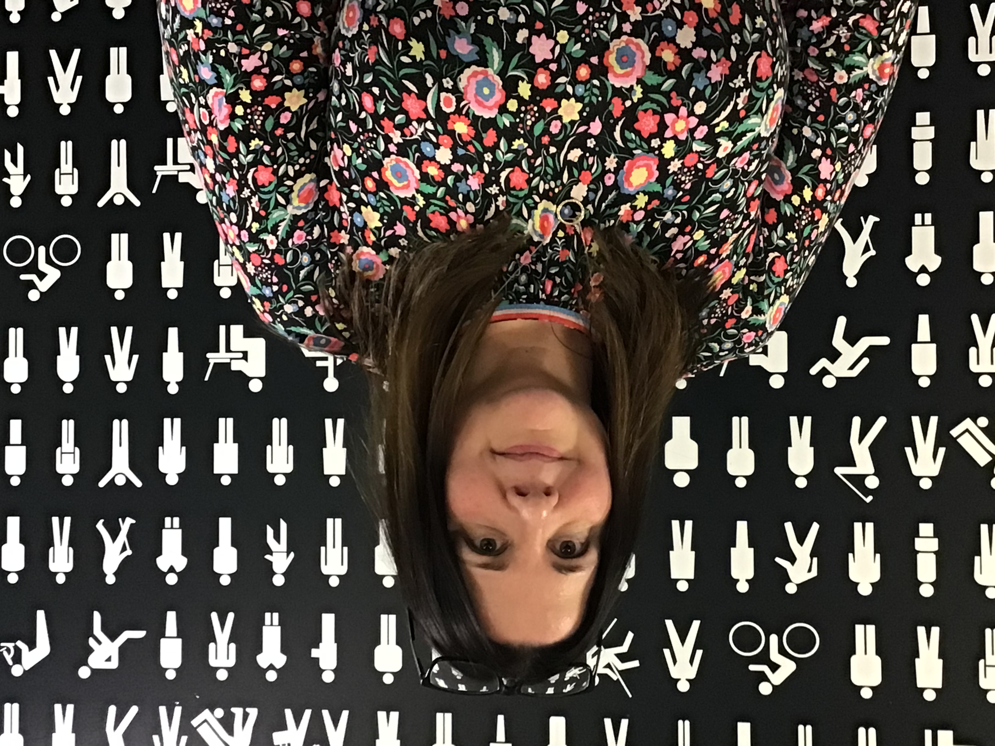 A woman with short brown hair smiling at the camera. 