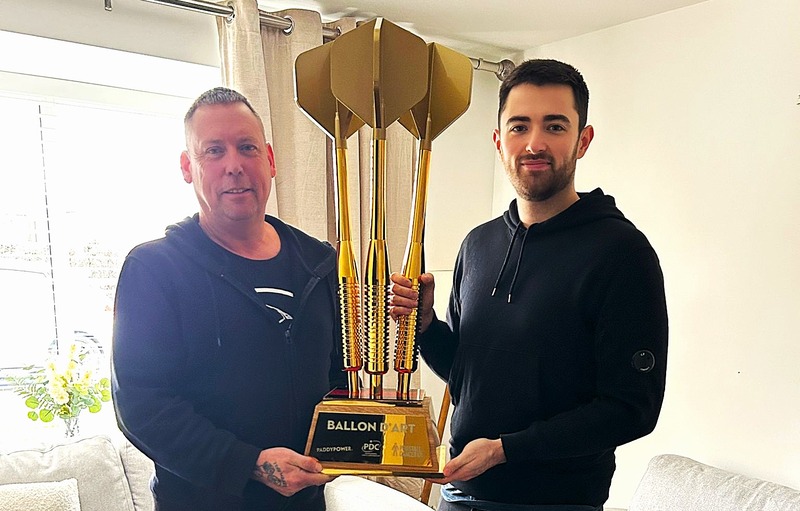 Luke Humphries and his father-in-law Peter Jones hold the Ballon d'Art trophy between them.