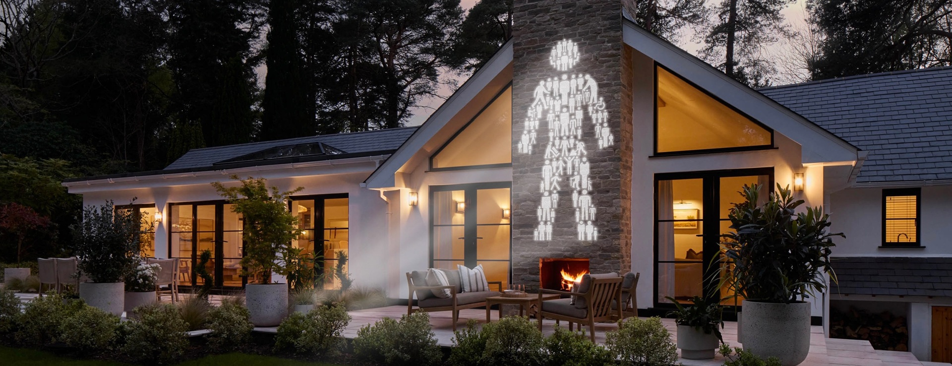 Prostate Cancer UK's 'Man of Men' logo projected onto the side of a large house in the countryside.