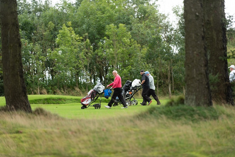 Golfers walking on the course
