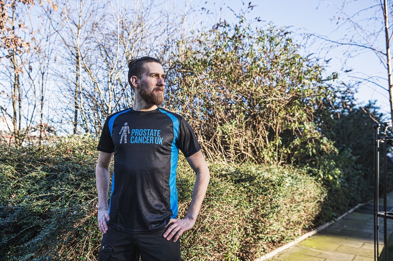A male runner wearing a Prostate Cancer UK running top 