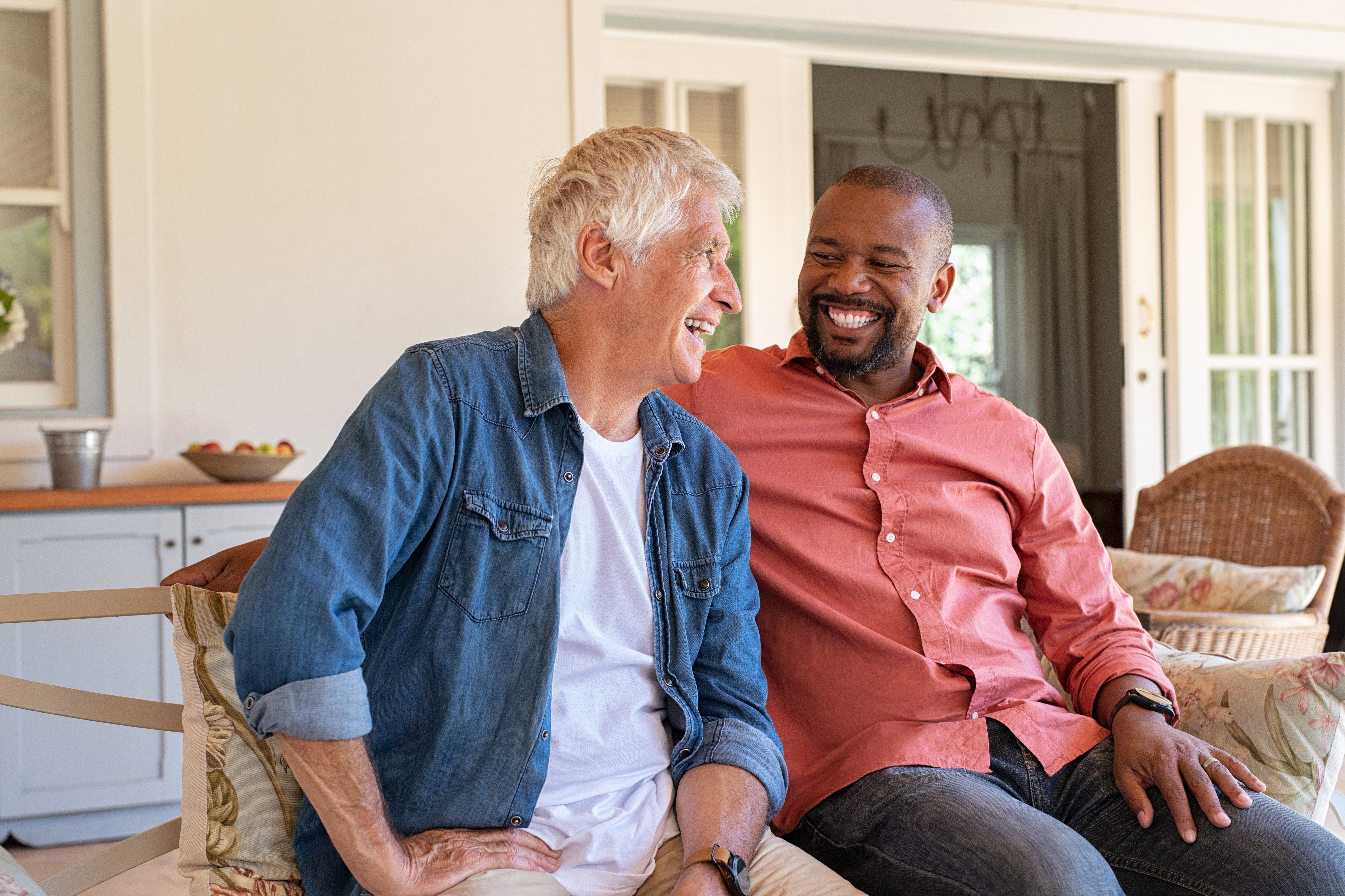 2 men chatting with a smile