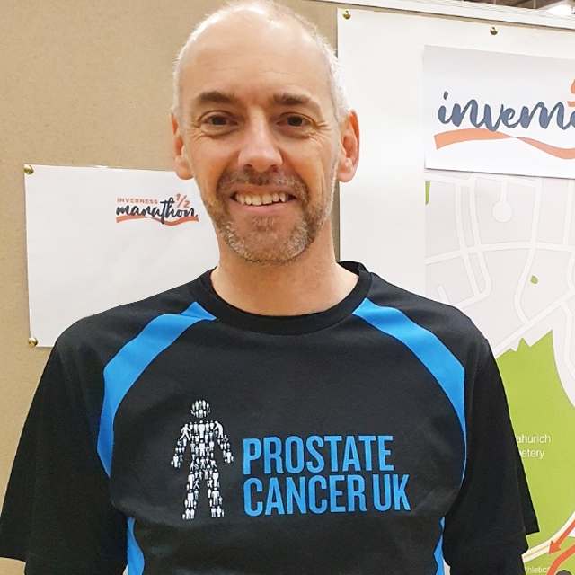 A man wearing a Prostate Cancer UK running top 