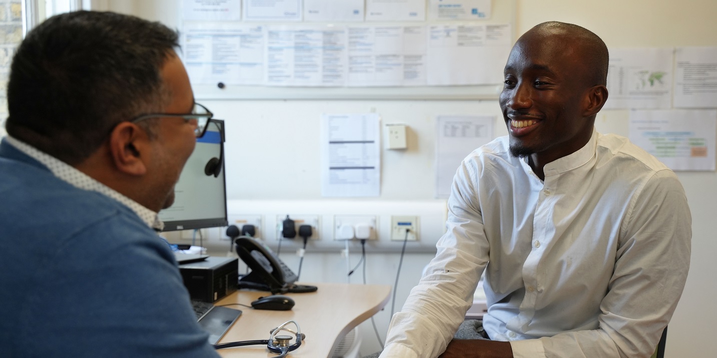 man chatting with GP doctor